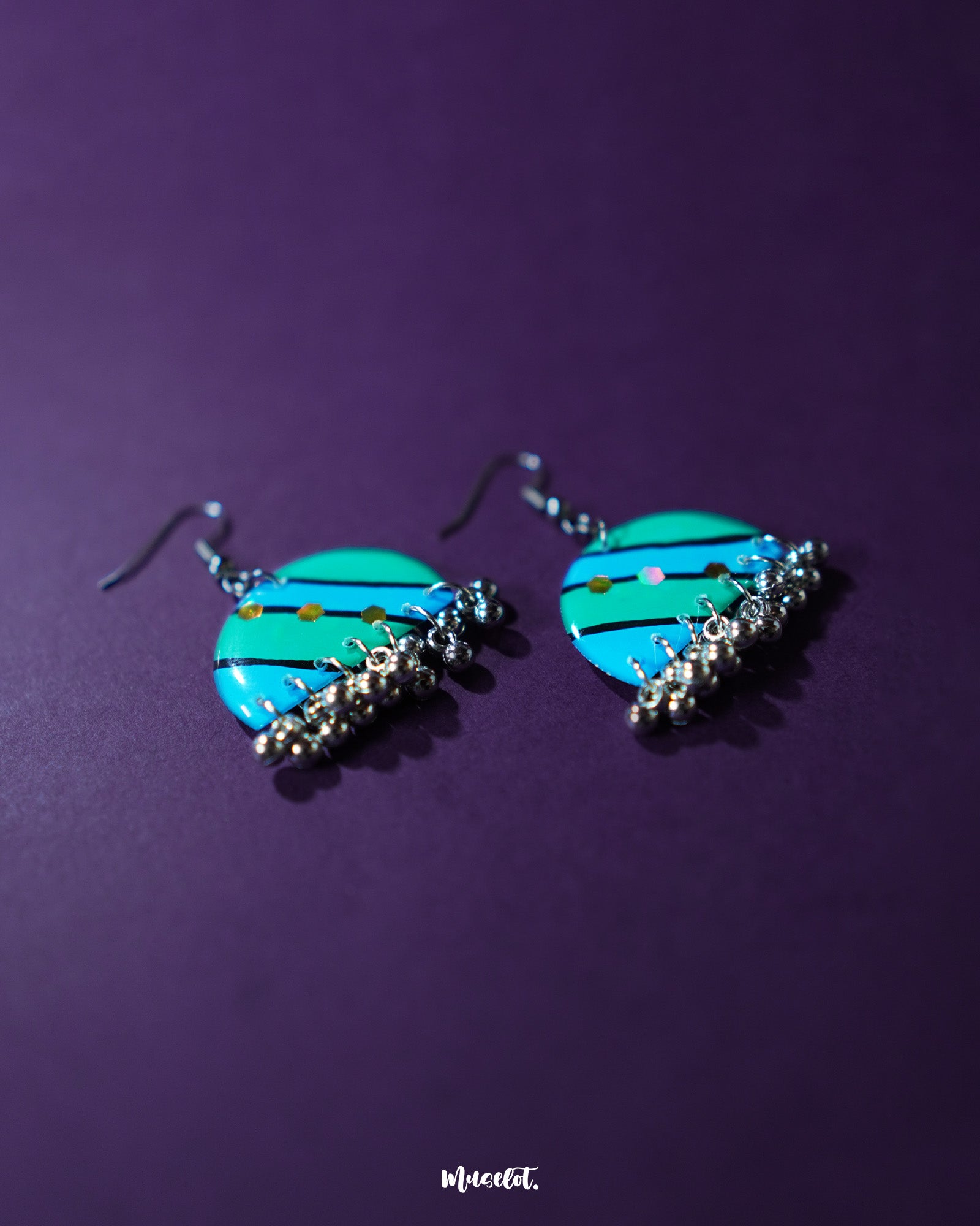 A pair of Jaltarang strip earrings rests gracefully, showcasing their sleek with fine detailing and artistic simplicity—Muselot.