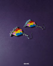 Jharokhe multicolor floral hook earrings displayed at an angle, highlighting the layered floral motifs in vivid hues and the intricate ghungroo accents that add movement and festive flair — Muselot.