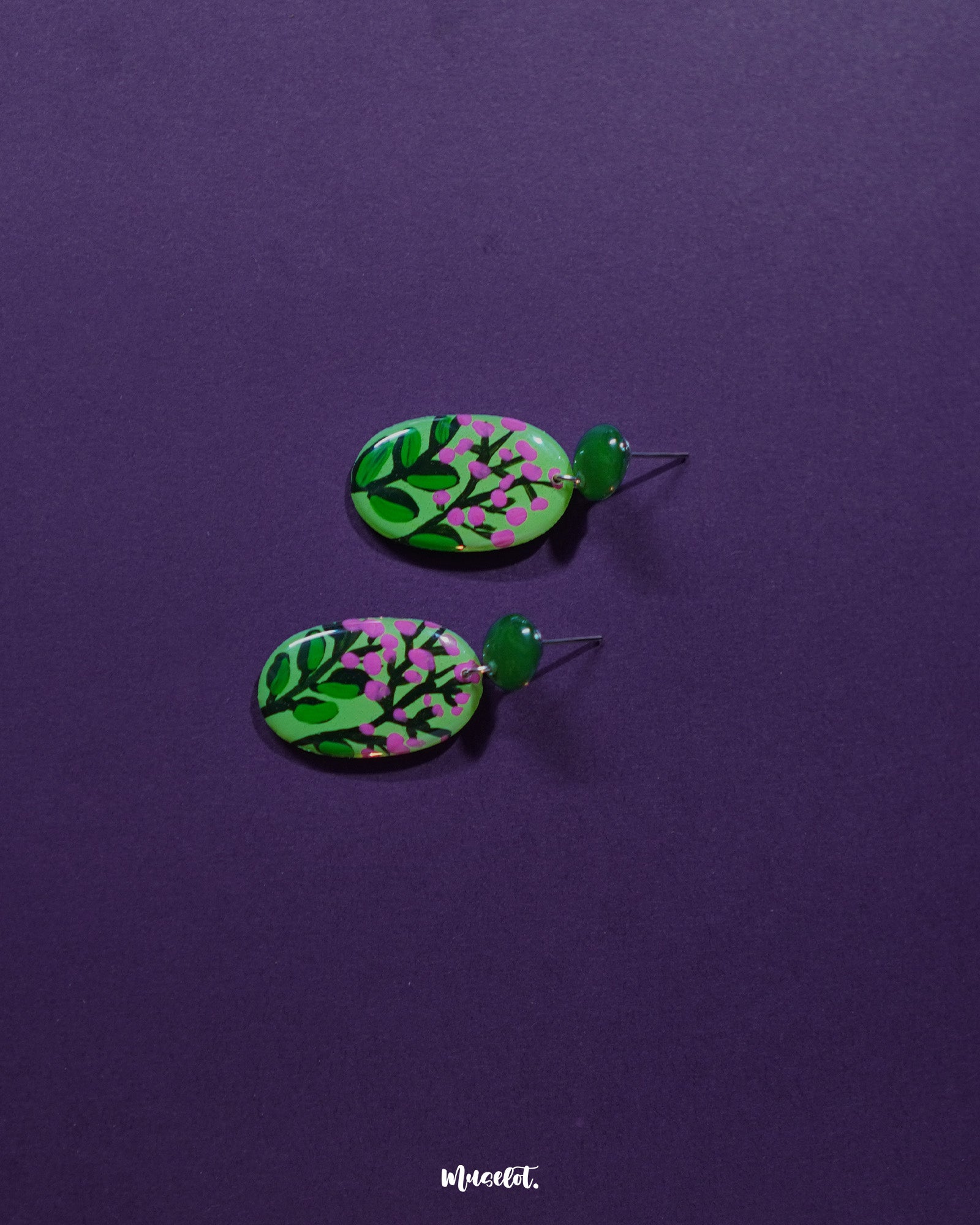 A detailed view of the Kalibaan drop earrings laid out on a soft neutral surface, showcasing their bold oxidized finish, intricate floral motif, and handcrafted charm that stands out effortlessly — Muselot.