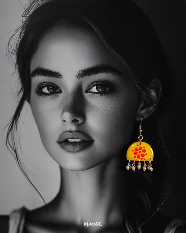 a model wearing Kesarika floral earrings, showcasing detailed floral motifs and subtle earthy hues that beautifully complement the look with a blend of elegance and tradition — Muselot.