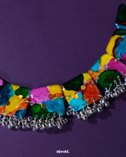 A close-up view of the Kohsar colorful necklace placed on a deep purple background, highlighting the vivid mix of multicolored beads, intricate detailing, and artisanal charm of the necklace— Muselot.