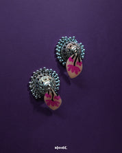 Front display of Kumudini pink lotus jhumkas, showcasing the floral dome and subtle hand-painted details against a simple background – Muselot.