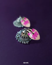 Close view of Kumudini pink lotus jhumkas, emphasizing the lotus bloom design and intricate enamel work against a plain background – Muselot.