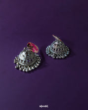 Detailed view of Kumudini pink lotus jhumkas, highlighting the floral dome design and handcrafted finish against a plain background – Muselot.