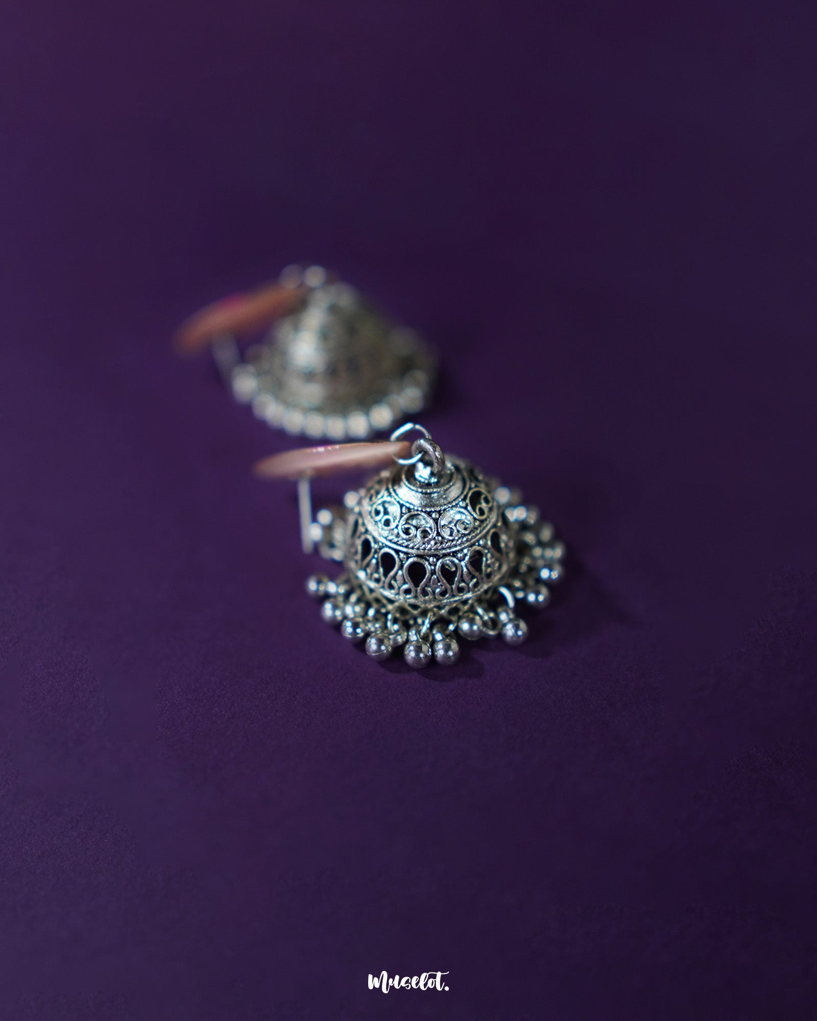 Pair of Kumudini pink lotus jhumkas displayed together, showcasing symmetrical floral domes and detailed craftsmanship on a clean backdrop – Muselot.