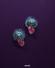 Artistic shot of Kumudini pink lotus jhumkas, capturing the lotus motif and intricate metalwork with a clean background – Muselot.