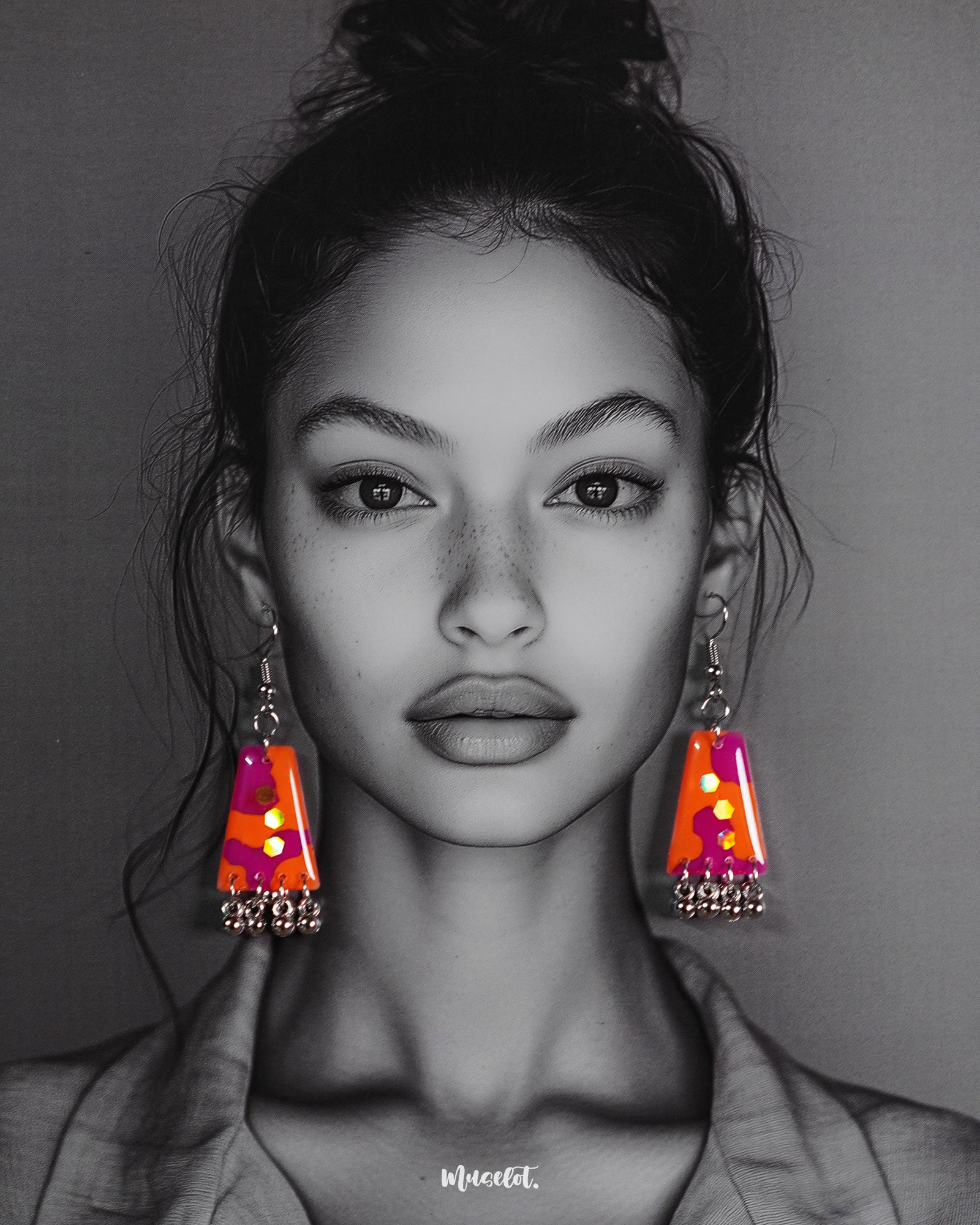 A model wearing the Laalsavera drop earrings, showcasing the rich red tones and intricate detailing that lend an elegant flair to the look, making a bold yet graceful statement – Muselot