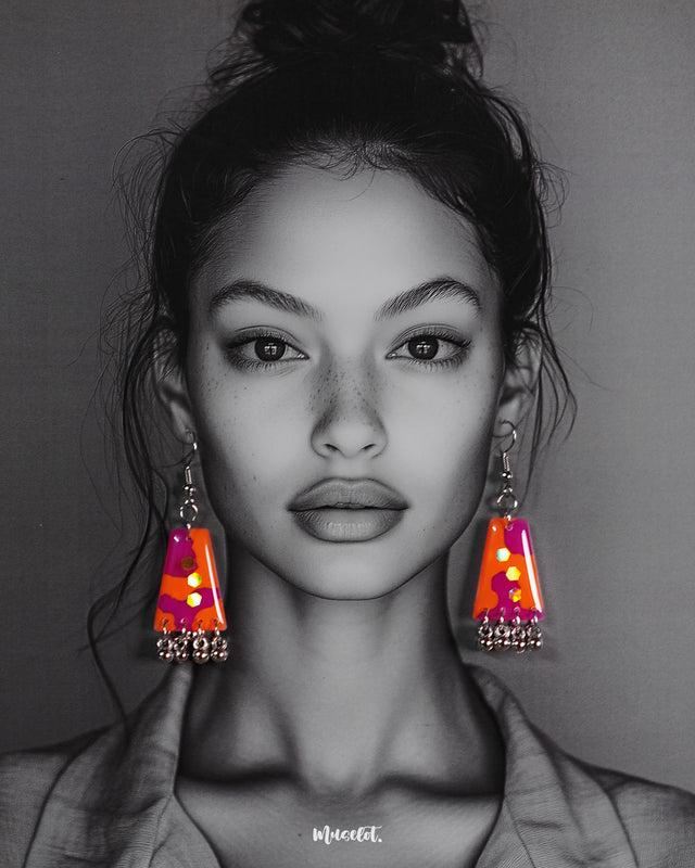 A model wearing the Laalsavera drop earrings, showcasing the rich red tones and intricate detailing that lend an elegant flair to the look, making a bold yet graceful statement – Muselot