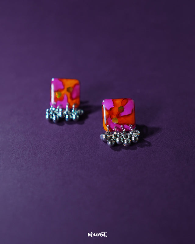 The Laalsavera stud earrings feature a timeless design, with elegant craftsmanship, beautifully highlighted against a purple backdrop — Muselot.