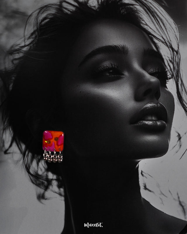 The model wearing the Laalsavera stud earrings, with the deep background subtly highlighting the earrings elegant design and making them stand out as a statement piece – Muselot