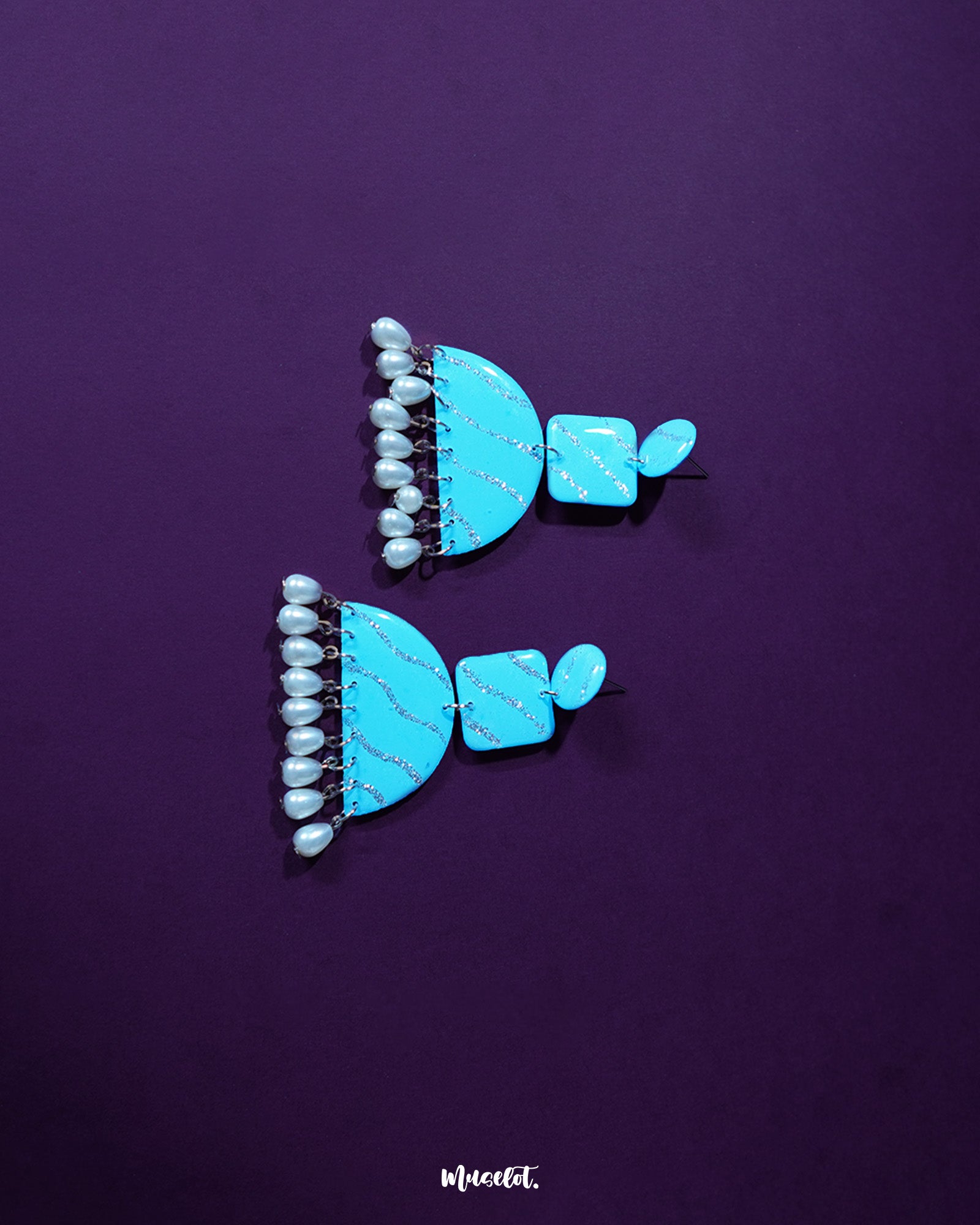 Lehrbaan blue pearl jhumkas with delicate blue domes adorned in floral gold motifs, finished with lustrous pearl drops for a graceful, festive charm — Muselot.