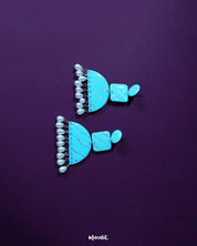 Lehrbaan blue pearl jhumkas with delicate blue domes adorned in floral gold motifs, finished with lustrous pearl drops for a graceful, festive charm — Muselot.