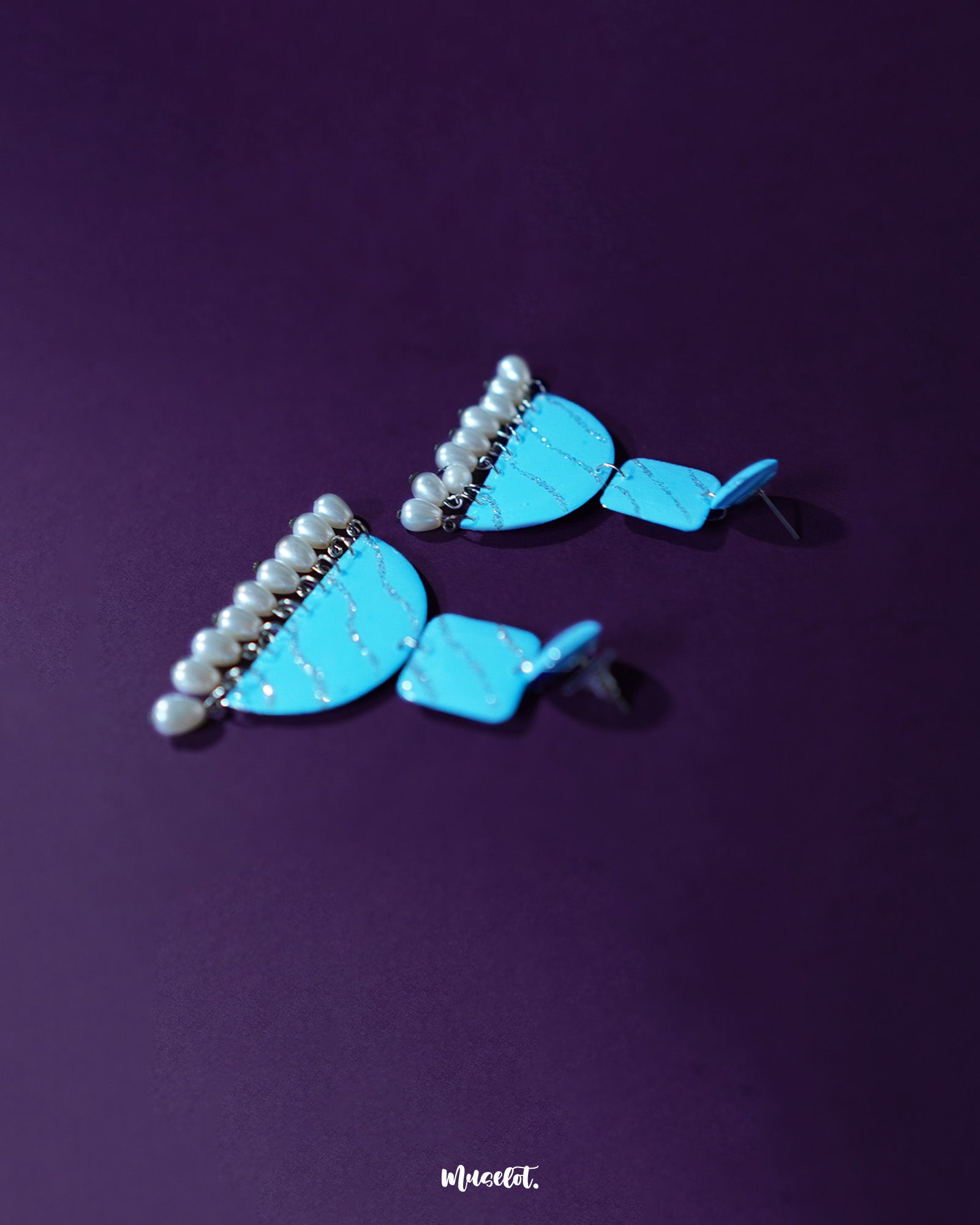 Lehrbaan blue pearl jhumkas showcasing intricate gold detailing and soft pearl accents, exuding elegance with every sway — Muselot.