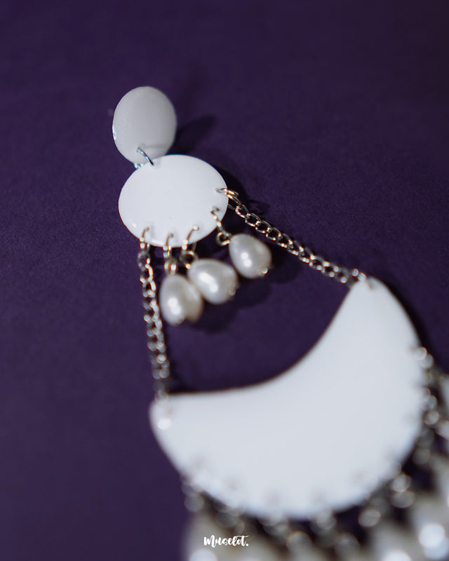 Close-up of Mahtab pearl chandbali earrings revealing intricate detailing of glossy white enamel and delicately suspended teardrop pearls, showcasing timeless charm and refined craftsmanship — Muselot.