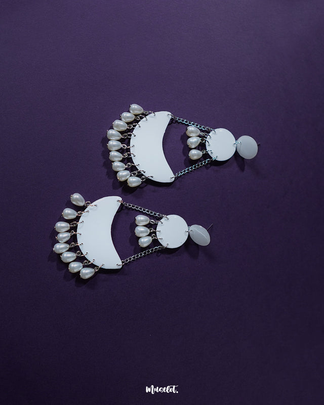 Mahtab pearl chandbali earrings placed on a soft neutral background, highlighting the crescent shape, dainty pearl accents, and the intricate handcrafted design that exudes timeless charm — Muselot.