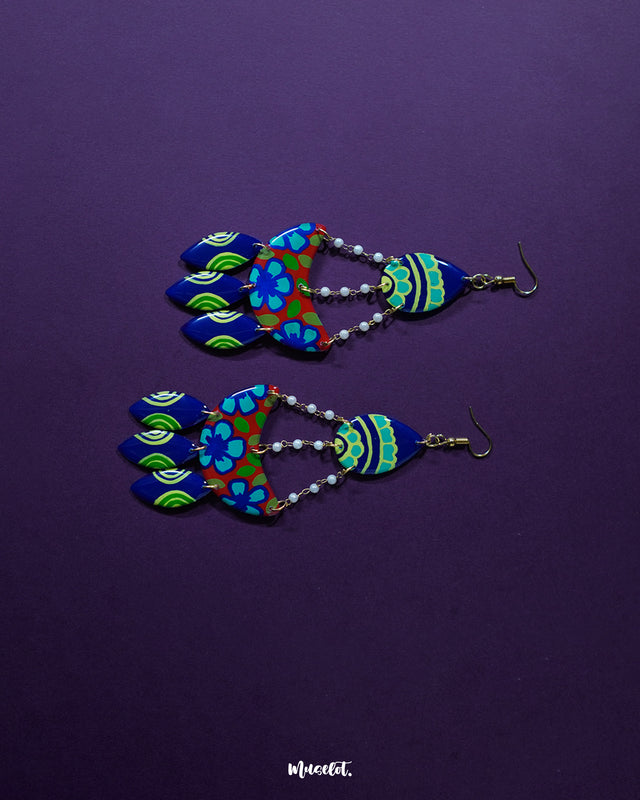 Mayoori chandbali earrings, showcased against a rich purple background, with detailed patterns and an elegant design that exude a traditional yet contemporary appeal, enhancing their timeless beauty — Muselot.