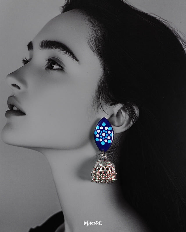 A woman wearing Meghmalhar traditional jhumkas featuring oxidized silver domes and hand-painted blue tops with dotted patterns, showcasing timeless elegance with a handcrafted ethnic appeal — Muselot.