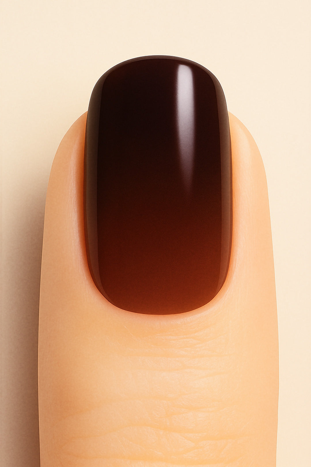A close-up shot of a model’s finger wearing Melted Cocoa Ombre Nail Stickies, showcasing a deep gradient that transitions from warm brown at the base to rich dark cocoa at the tip, highlighting the glossy finish and sophisticated ombre effect – Muselot.