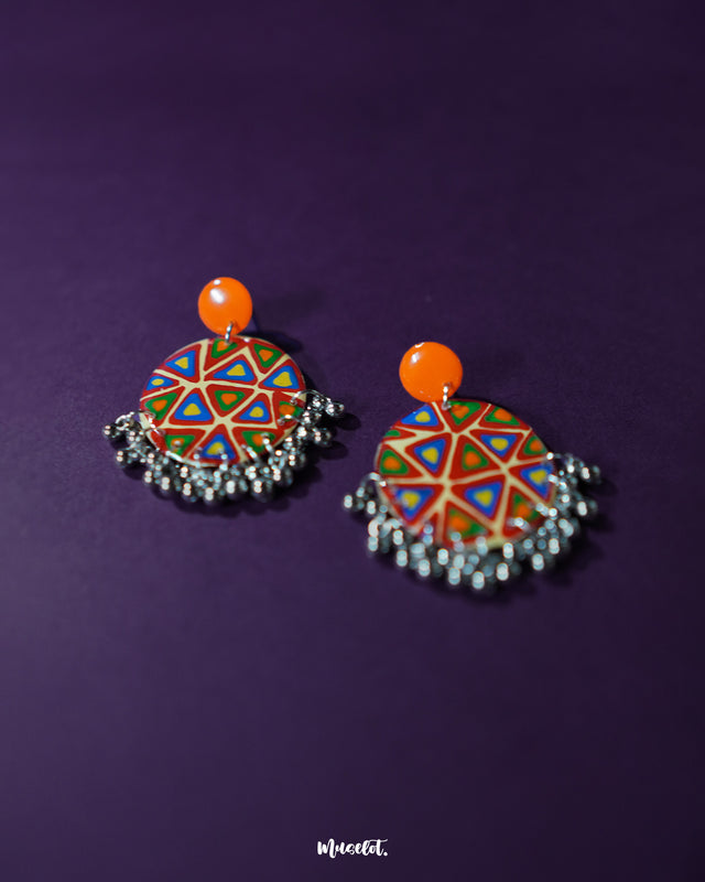 Multi-color Chakardi traditional earrings, set against a rich purple background, featuring vibrant hues and intricate patterns that showcase the beauty of traditional craftsmanship with a modern flair — Muselot.