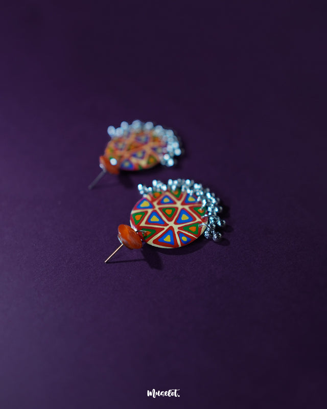 Multi-color Chakardi traditional earrings, displayed against a soft backdrop, with bold, vibrant colors and intricate detailing that bring out their cultural richness and timeless elegance — Muselot.