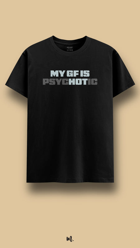 Black graphic t-shirt showcasing the statement “MY GF IS PSYCHOTIC” in strong block lettering with tonal contrast emphasis, highlighting provocative, sarcastic couple humor against a clean beige studio backdrop – Muselot