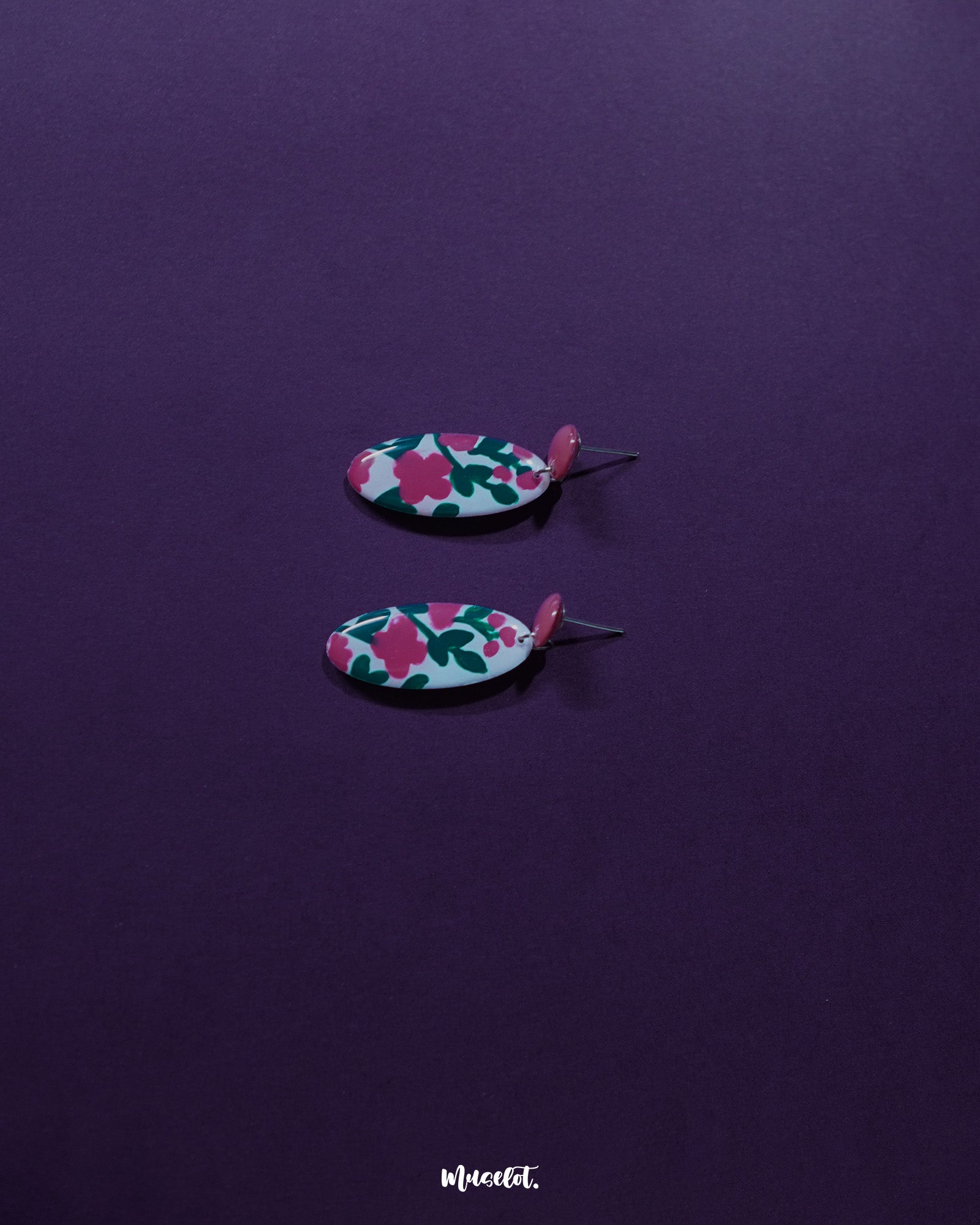 A detailed view of the Nargis pink floral drop earrings placed against a soft backdrop, showcasing the delicate design, handcrafted petals, and elegant color blend — Muselot.