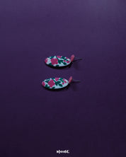 A detailed view of the Nargis pink floral drop earrings placed against a soft backdrop, showcasing the delicate design, handcrafted petals, and elegant color blend — Muselot.