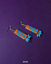 Narmshaam handmade hook earrings displayed against a soft neutral background, showcasing their delicate floral motifs, colorful hand-painted details, and lightweight artisanal design — Muselot