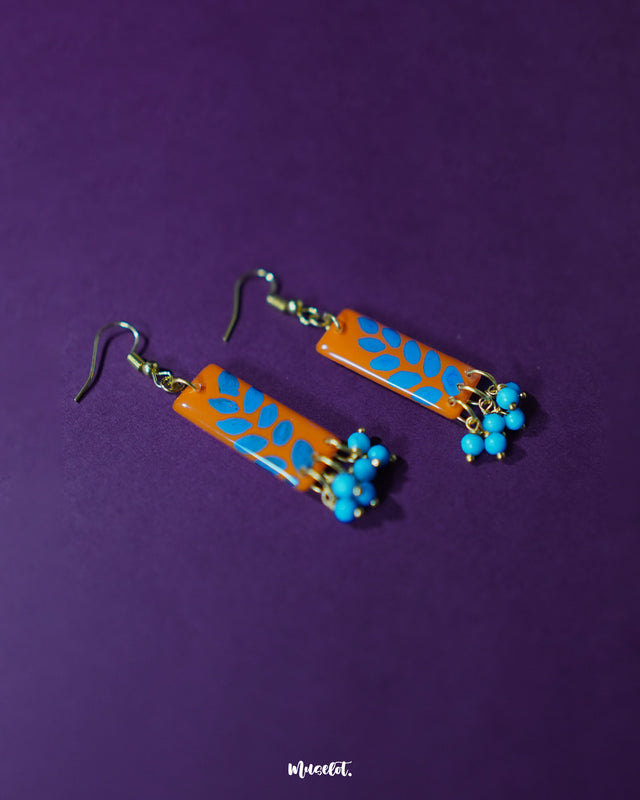 Narmshaam handmade hook earrings displayed against a soft neutral background, showcasing their delicate floral motifs, colorful hand-painted details, and lightweight artisanal design — Muselot