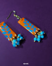 Narmshaam handmade hook earrings displayed against a soft neutral background, showcasing their delicate floral motifs, colorful hand-painted details, and lightweight artisanal design — Muselot.