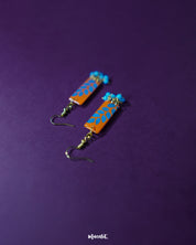 Narmshaam handmade hook earrings placed on a soft fabric, showcasing their delicate thread design, subtle color blend, and lightweight build perfect for adding an artsy charm to everyday looks — Muselot.