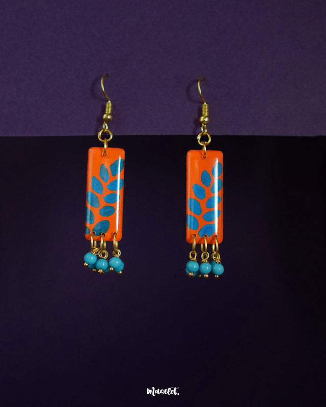 Narmshaam stud drop earrings featuring a dual-tone design with intricate floral accents, blending elegance and everyday charm, perfect for adding a graceful touch to any look — Muselot.