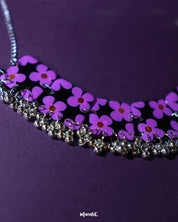 Naubahar purple necklace set featuring delicate lavender floral accents, elegantly displayed on a deep purple background, showcasing its intricate design and sophisticated charm — Muselot.