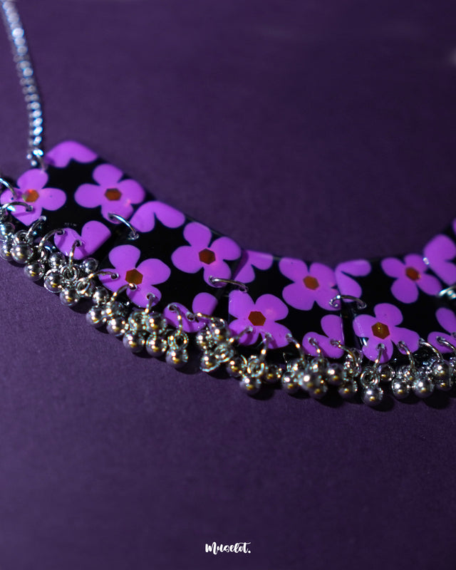 Naubahar purple necklace set featuring delicate lavender floral accents, elegantly displayed on a deep purple background, showcasing its intricate design and sophisticated charm — Muselot.