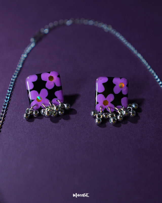 Naubahar purple earrings, adorned with soft lavender flowers, elegantly presented against a deep purple background, emphasizing their delicate floral design and intricate craftsmanship — Muselot