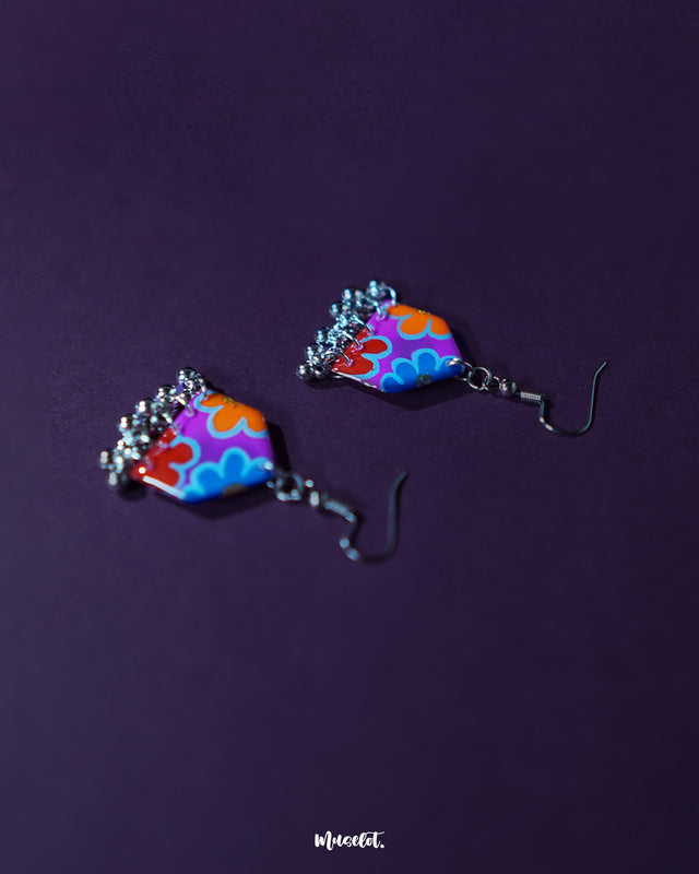 Nazrana multicolour floral earrings with hand-painted patterns and silver ghungroo drops, displayed against a purple background to showcase their vibrant boho style – Muselot.