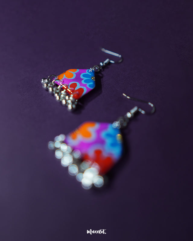 Angle view of Nazrana multicolour floral earrings, highlighting the hand-painted motifs and silver ghungroo detailing on a clean backdrop – Muselot.