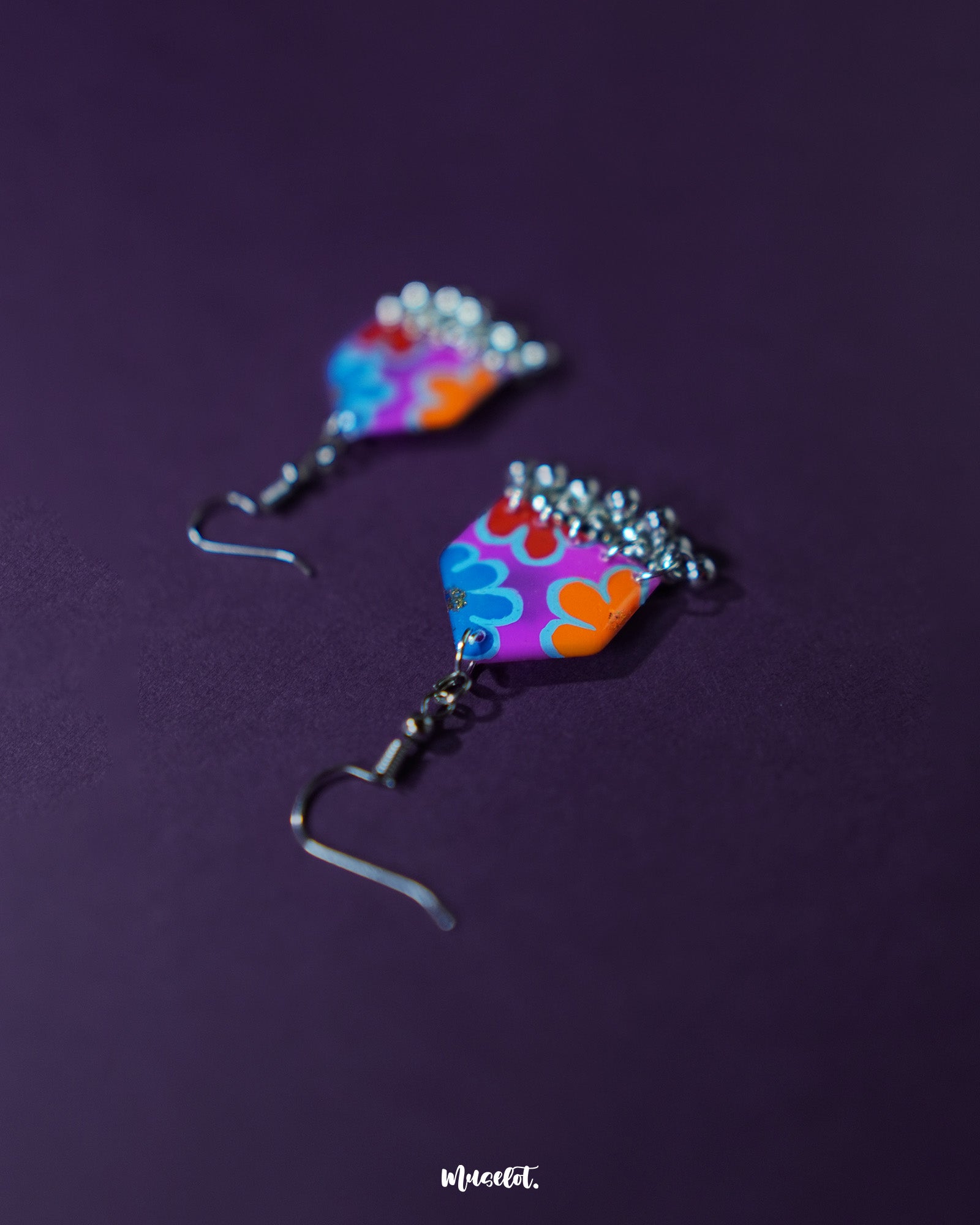 Nazrana multicolour floral earrings displayed upright, showcasing intricate hand-painted artwork and dangling silver ghungroos on a clean background – Muselot.