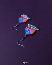 Close-angle shot of Nazrana multicolour floral earrings, highlighting the artistic brushwork and silver ghungroo detailing against a plain backdrop – Muselot.