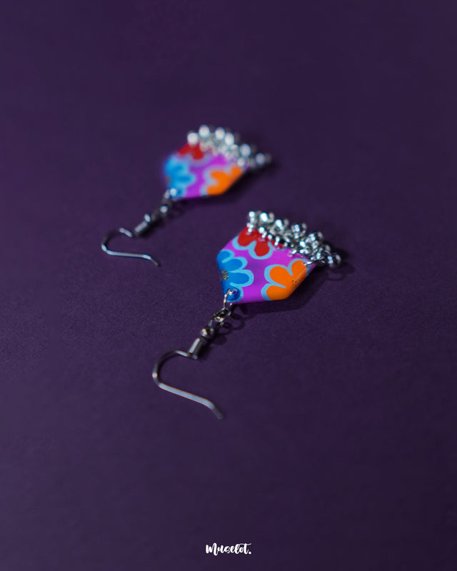Close-angle shot of Nazrana multicolour floral earrings, highlighting the artistic brushwork and silver ghungroo detailing against a plain backdrop – Muselot.