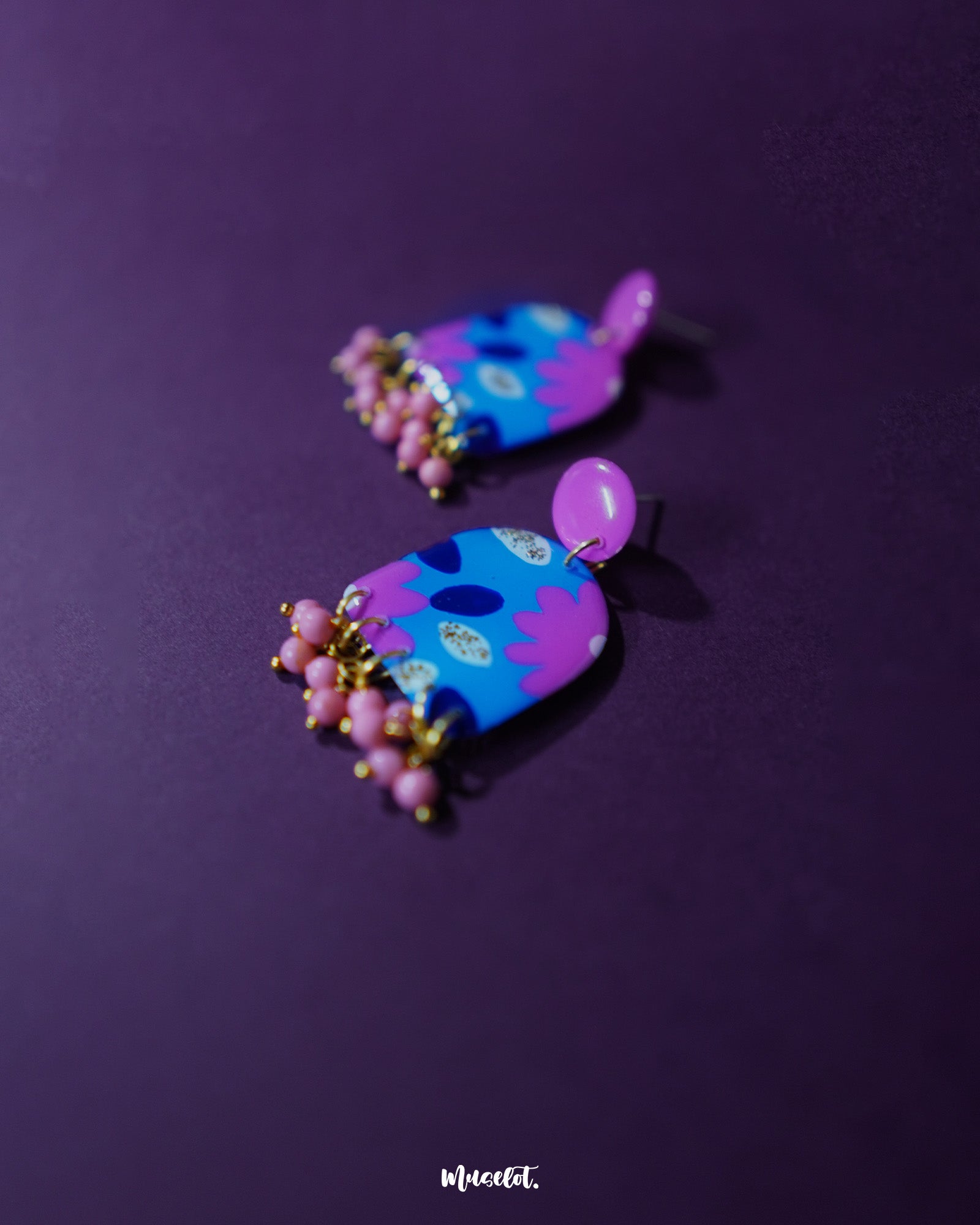 A close-up shot of the Neelzair purple floral earrings, highlighting the delicate petal arrangement and subtle shimmer, showcasing the handmade charm and elegant drop design — Muselot.