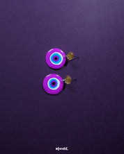 Nigaahbaan evil eye stud earrings featuring a striking deep blue center surrounded by pink, white, and purple concentric rings—playfully capturing the essence of protection with a vibrant handmade twist – Muselot.