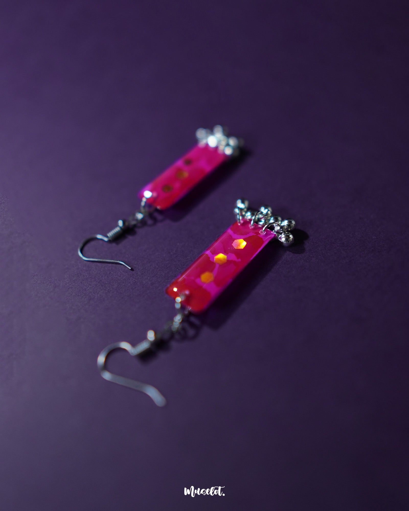 Noorasa drop earrings against a rich purple background, highlighting their intricate design and timeless elegance – Muselot