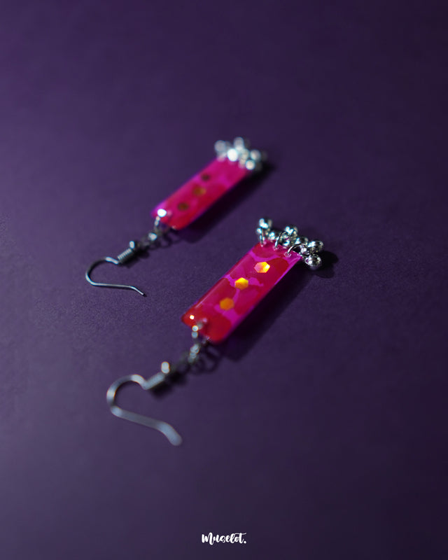 Noorasa drop earrings against a rich purple background, highlighting their intricate design and timeless elegance – Muselot