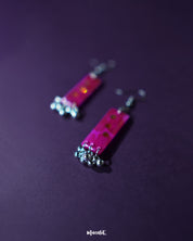 Noorasa drop earrings against a rich purple background, enhancing their elegant design – Muselot