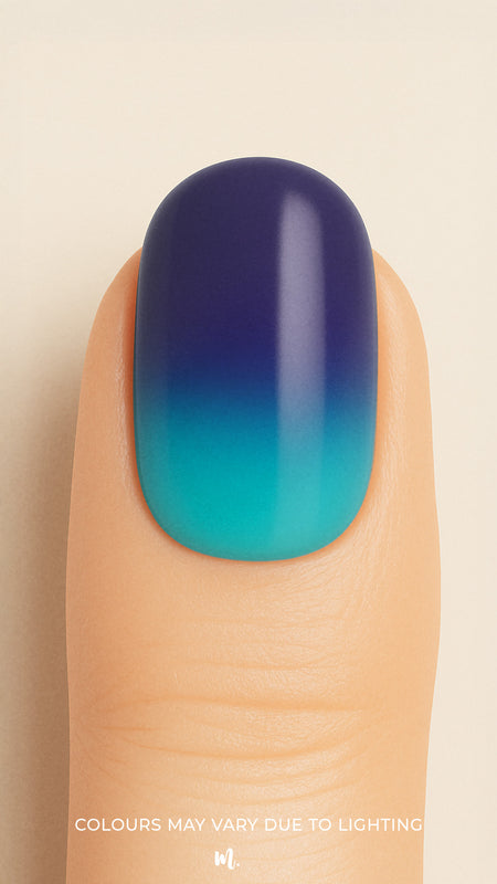 A close-up shot of a model’s finger wearing Ocean Dip Ombre Nail Stickies, showcasing a smooth gradient that blends deep navy blue into aqua teal, highlighting the ocean-inspired tones and glossy salon-like finish that make ombre nails stand out – Muselot.