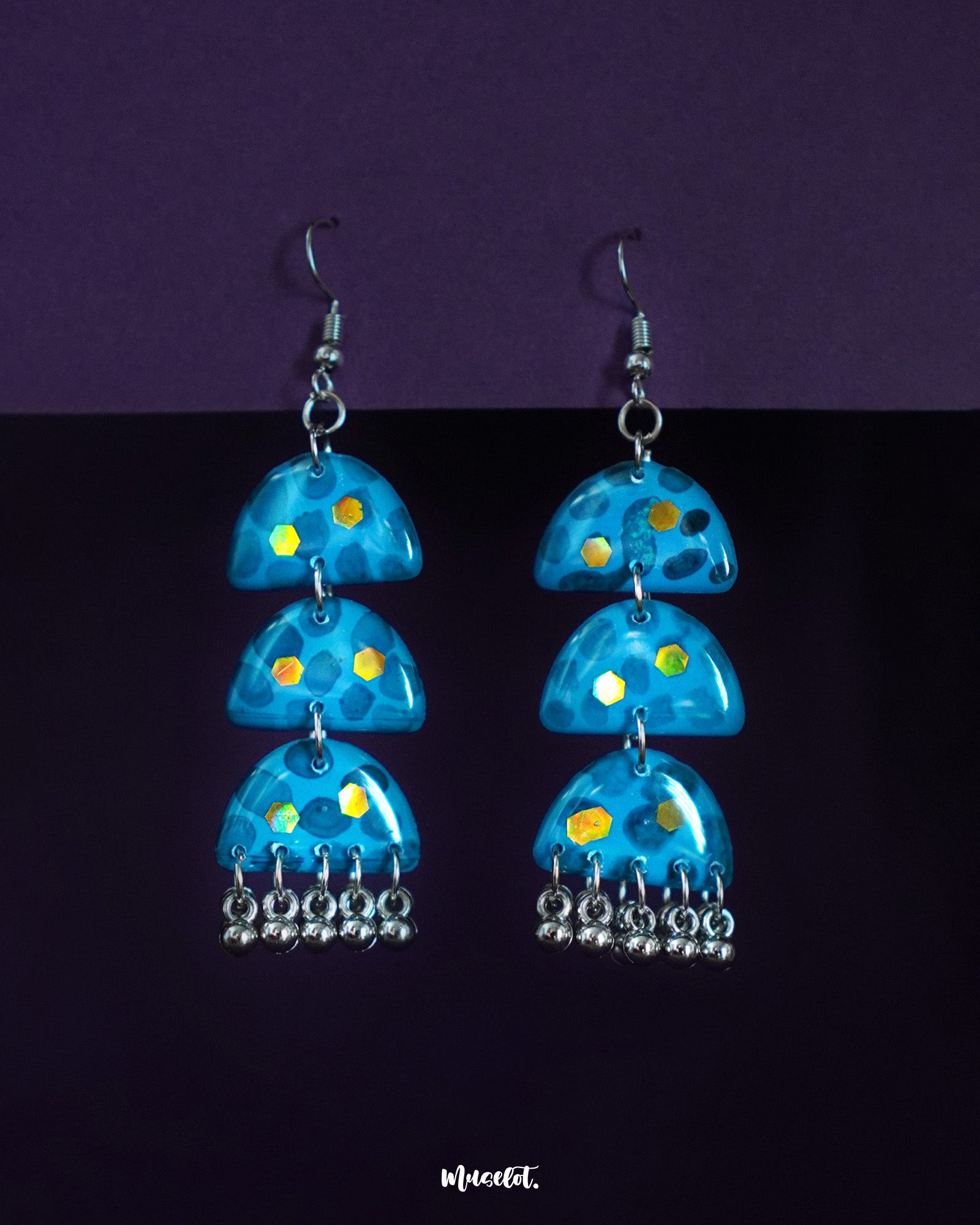 Parvaaz handmade blue drop earrings featuring a graceful teardrop shape with floral detailing, highlighting their bold yet elegant design and showcasing the perfect balance of tradition and modern flair — Muselot.