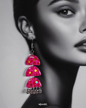 Close-up shot of a woman wearing Parvaaz handmade pink drop earrings, showcasing the intricate floral detailing and soft pastel hues that highlight the earrings’ gentle charm and artistic craftsmanship — Muselot.
