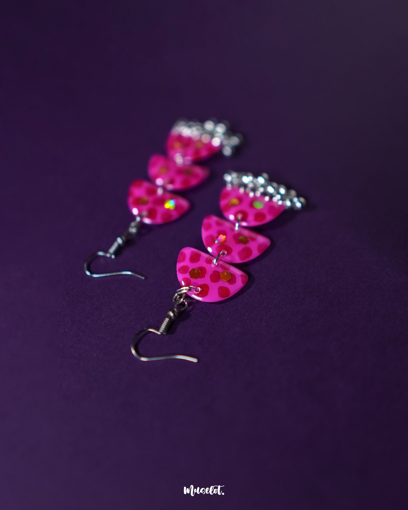 Parvaaz pink drop earrings laid out on a soft neutral surface, highlighting their delicate floral design and showcasing the pastel elegance perfect for graceful everyday wear — Muselot.