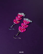 Parvaaz pink drop earrings laid out on a soft neutral surface, highlighting their delicate floral design and showcasing the pastel elegance perfect for graceful everyday wear — Muselot.